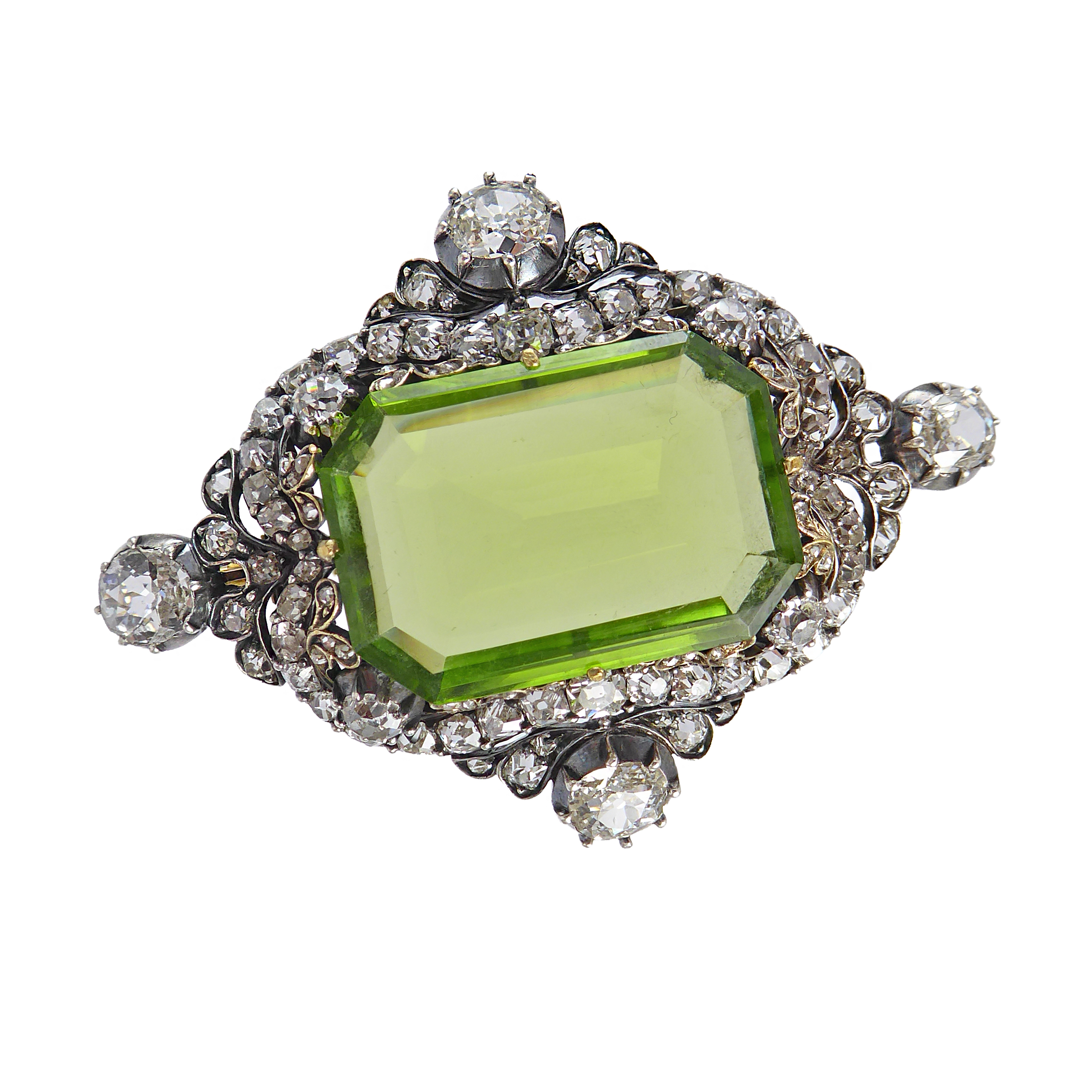 19th century peridot and diamond lozenge cluster brooch, c.1880, centred by a principal canted rectangular peridot, of step cut, approximately 25.30cts,